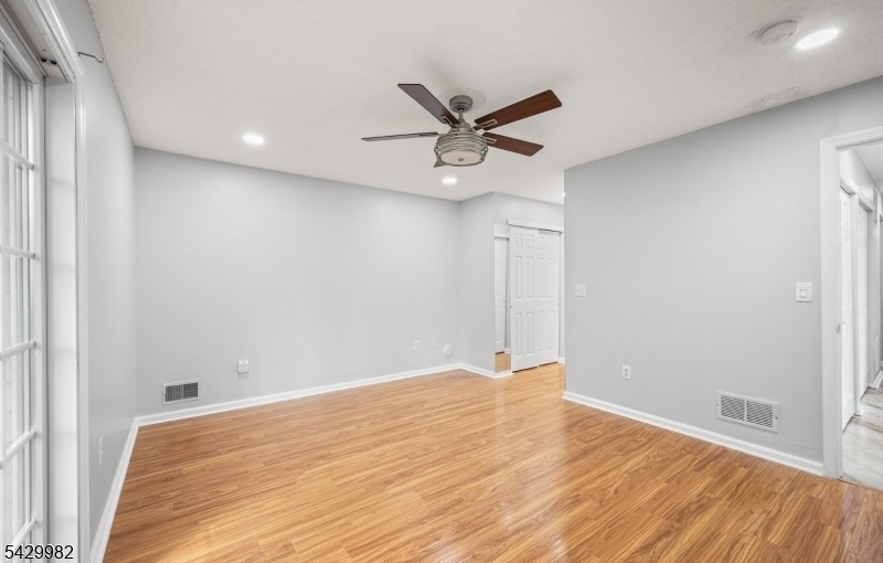 3702 Riddle Court, Unit 2 Bridgewater, NJ 08807 - Photo 14 of 20 a view of a room with wooden floor and a ceiling fan