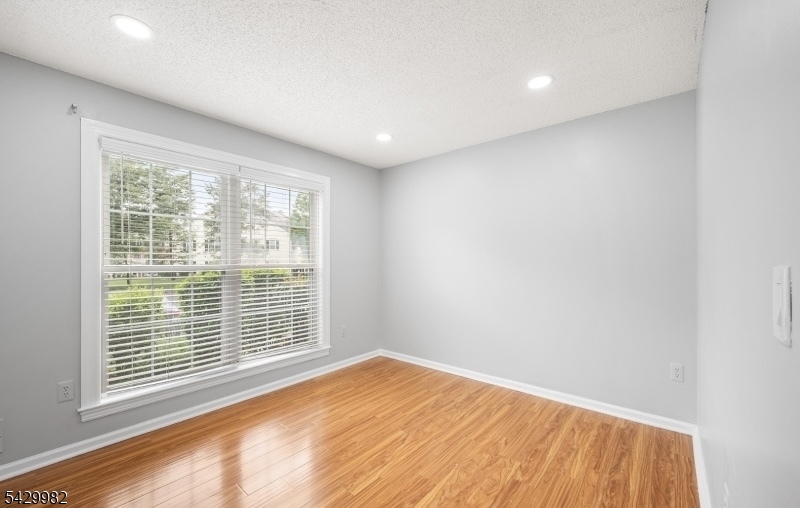 3702 Riddle Court, Unit 2 Bridgewater, NJ 08807 - Photo 15 of 20 a view of empty room with wooden floor and fan