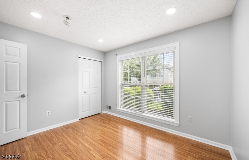 3702 Riddle Court, Unit 2 Bridgewater, NJ 08807 - Photo 16 of 20 a view of empty room with wooden floor and fan