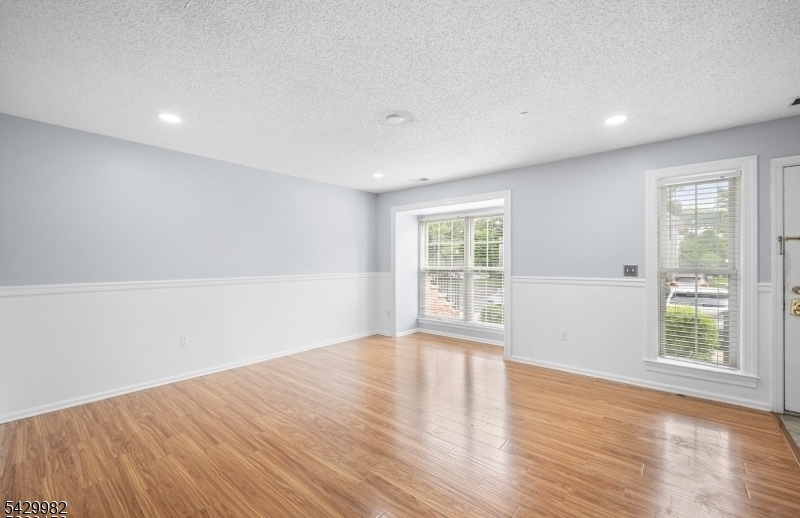 3702 Riddle Court, Unit 2 Bridgewater, NJ 08807 - Photo 3 of 20 a view of an empty room with wooden floor and a window