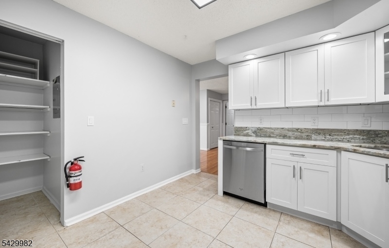 3702 Riddle Court, Unit 2 Bridgewater, NJ 08807 - Photo 9 of 20 a kitchen with granite countertop white cabinets and white appliances