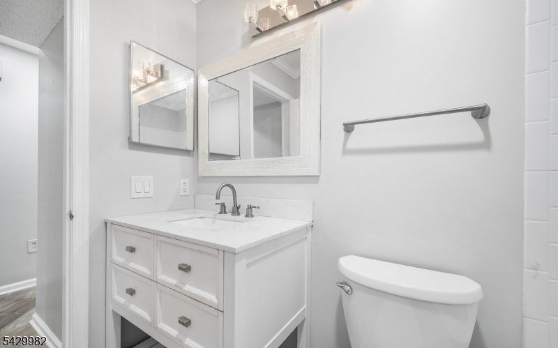 3702 Riddle Court, Unit 2 Bridgewater, NJ 08807 - Photo 10 of 20 a bathroom with a toilet sink and mirror