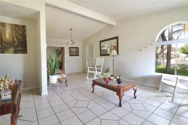 a living room with furniture and a floor to ceiling window