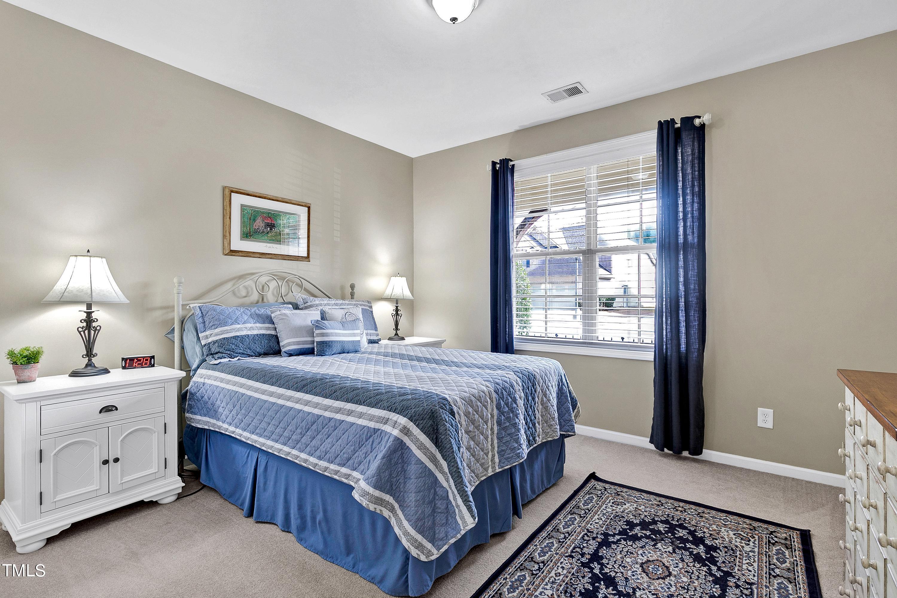6115 Leesburg Lane Raleigh, NC 27617 - Photo 30 of 46 a bedroom with double bed and a window