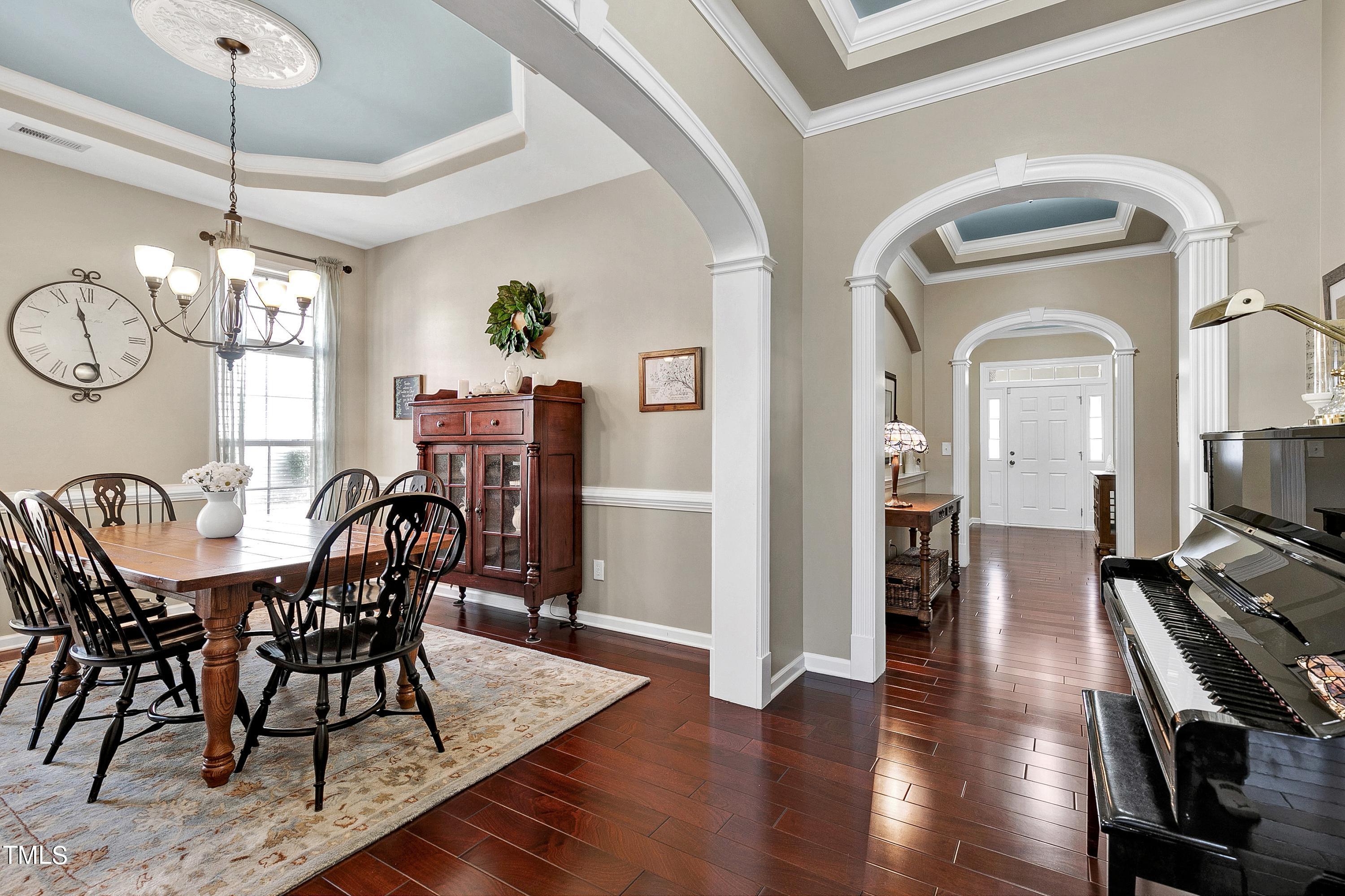 6115 Leesburg Lane Raleigh, NC 27617 - Photo 8 of 46 a view of a dining room with furniture wooden floor and chandelier