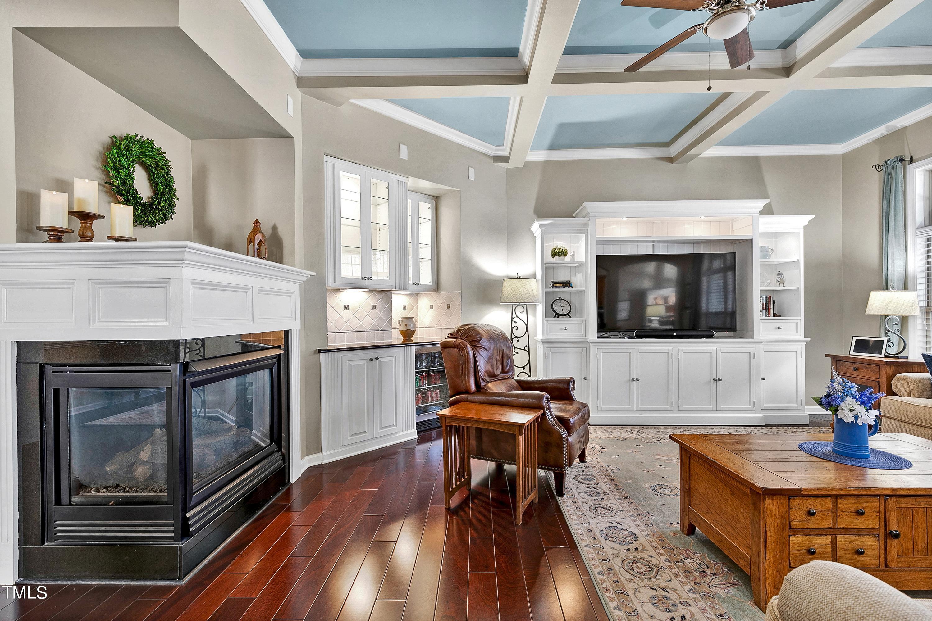 6115 Leesburg Lane Raleigh, NC 27617 - Photo 10 of 46 a living room with furniture a fireplace and a flat screen tv