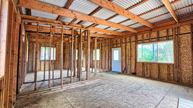 a backyard of a house with table and chairs
