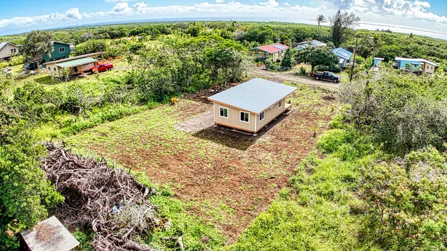 an aerial view of a house with yard and lake view