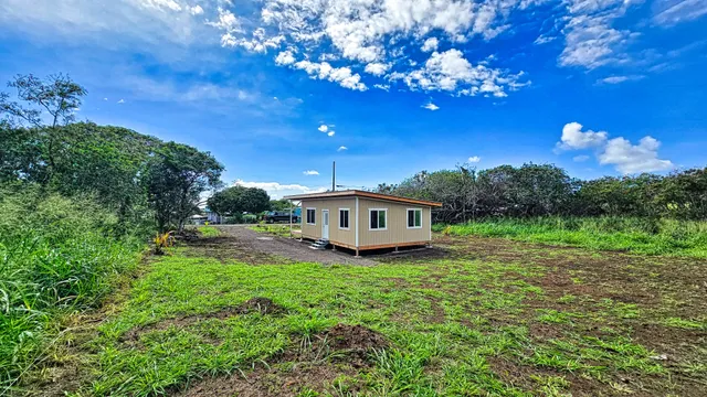 a view of a house with a backyard