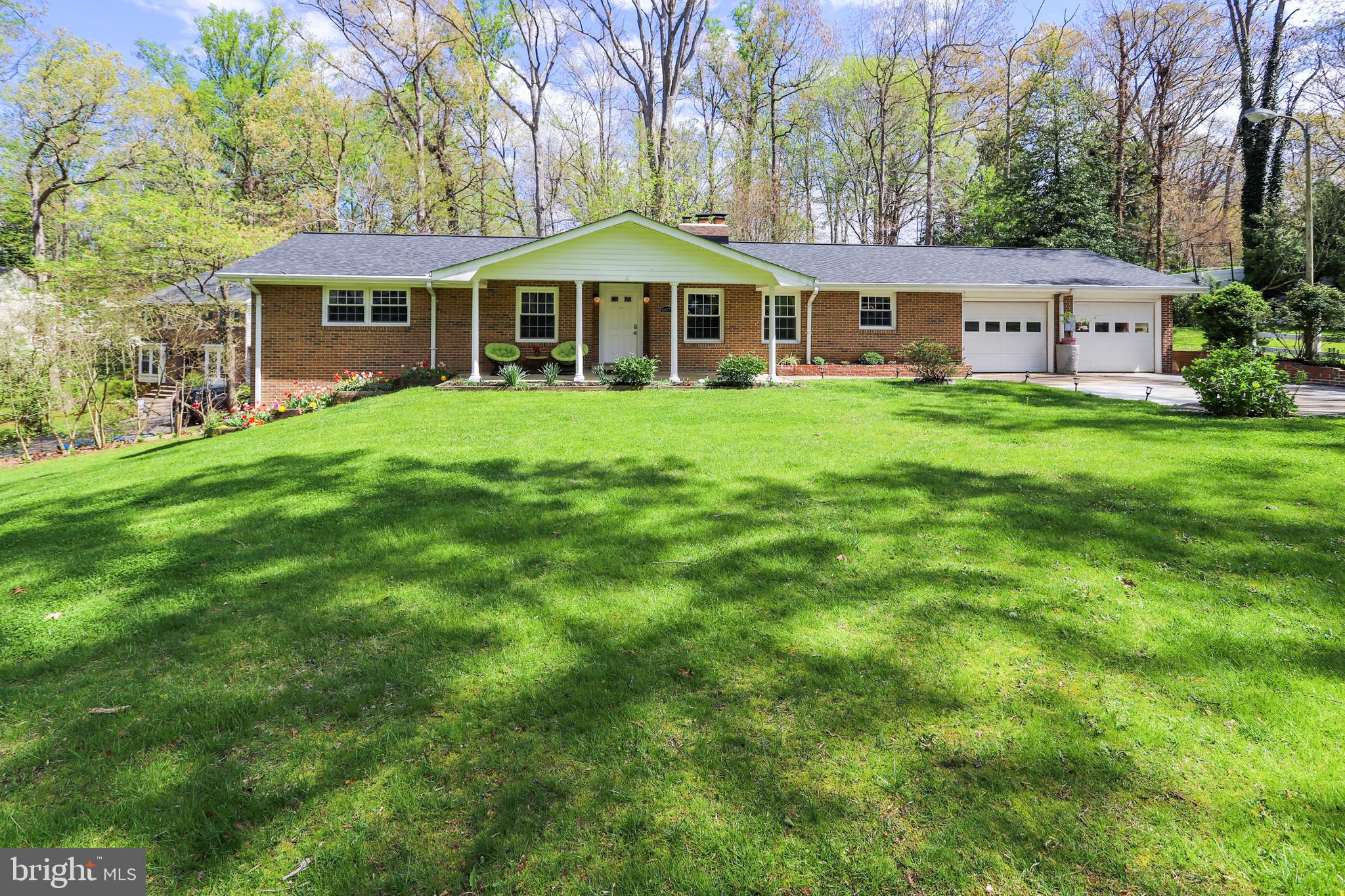 6671 Ridgeway Drive Springfield, VA 22150 - Photo 2 of 53 a front view of a house with a garden