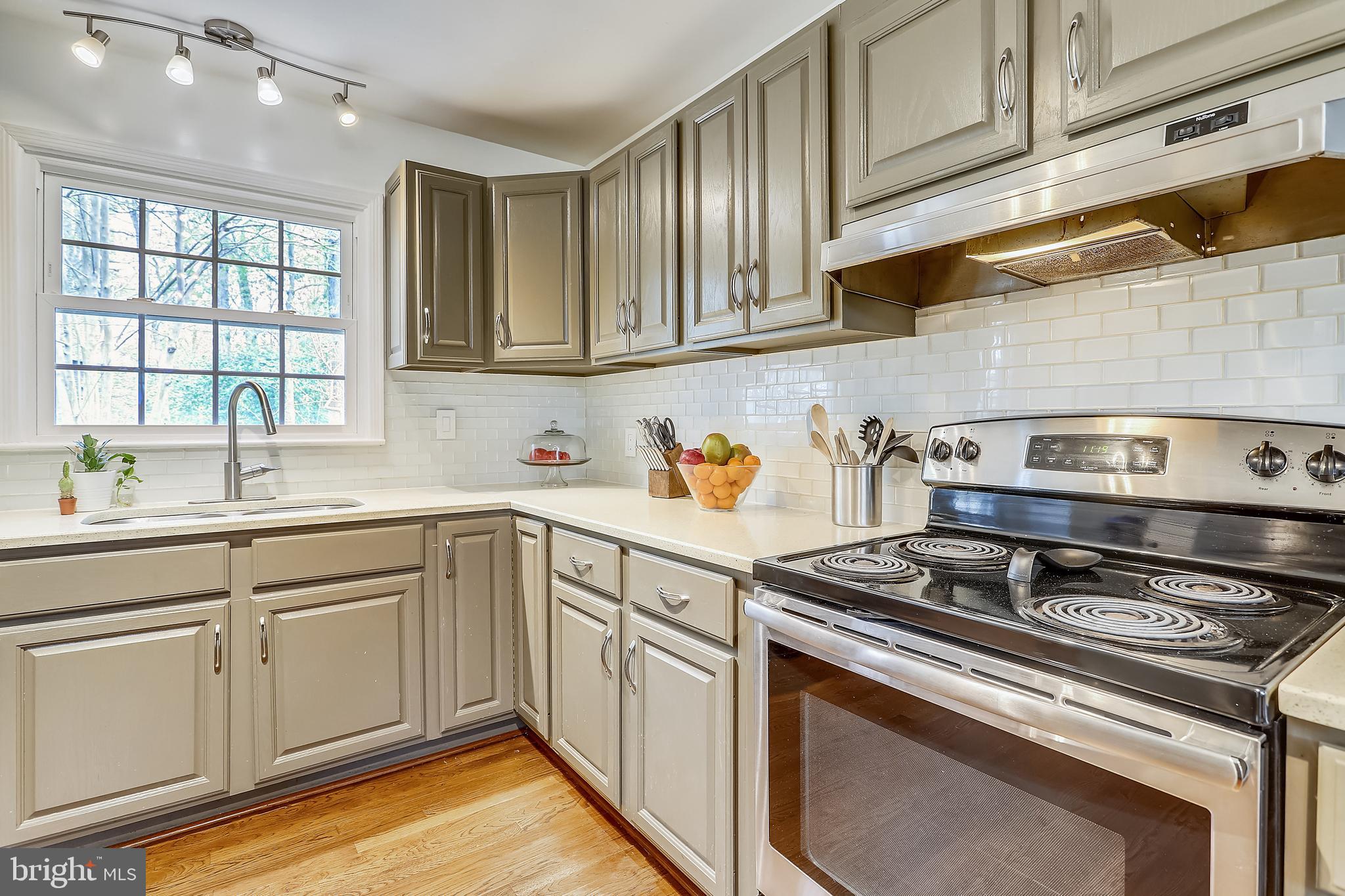 6671 Ridgeway Drive Springfield, VA 22150 - Photo 11 of 53 a kitchen with stainless steel appliances granite countertop a stove and a sink