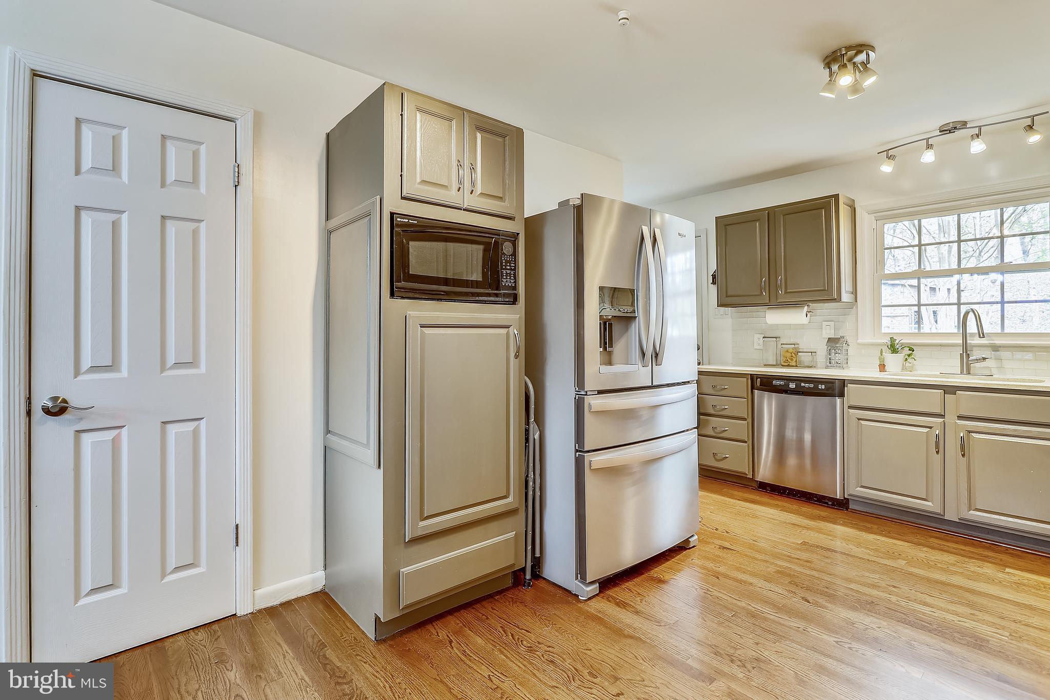 6671 Ridgeway Drive Springfield, VA 22150 - Photo 12 of 53 a kitchen with stainless steel appliances granite countertop a refrigerator and a stove top oven
