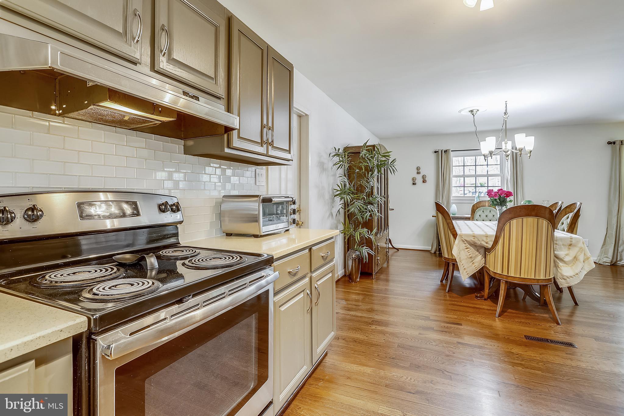 6671 Ridgeway Drive Springfield, VA 22150 - Photo 13 of 53 a kitchen with a stove and wooden floor