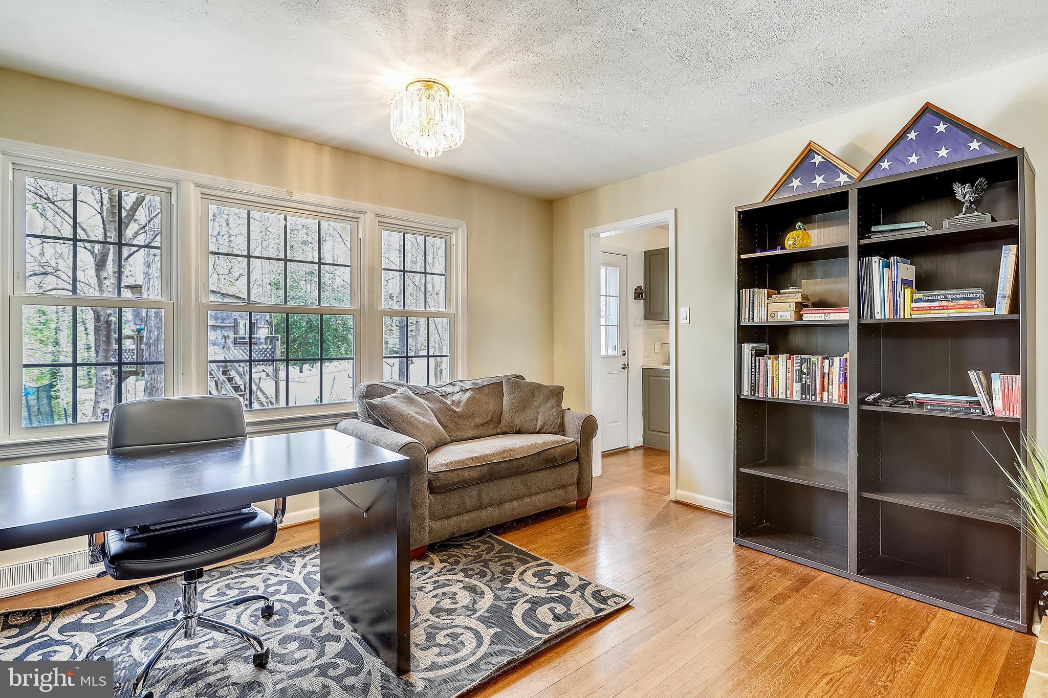 6671 Ridgeway Drive Springfield, VA 22150 - Photo 18 of 53 a living room with furniture and a book shelf