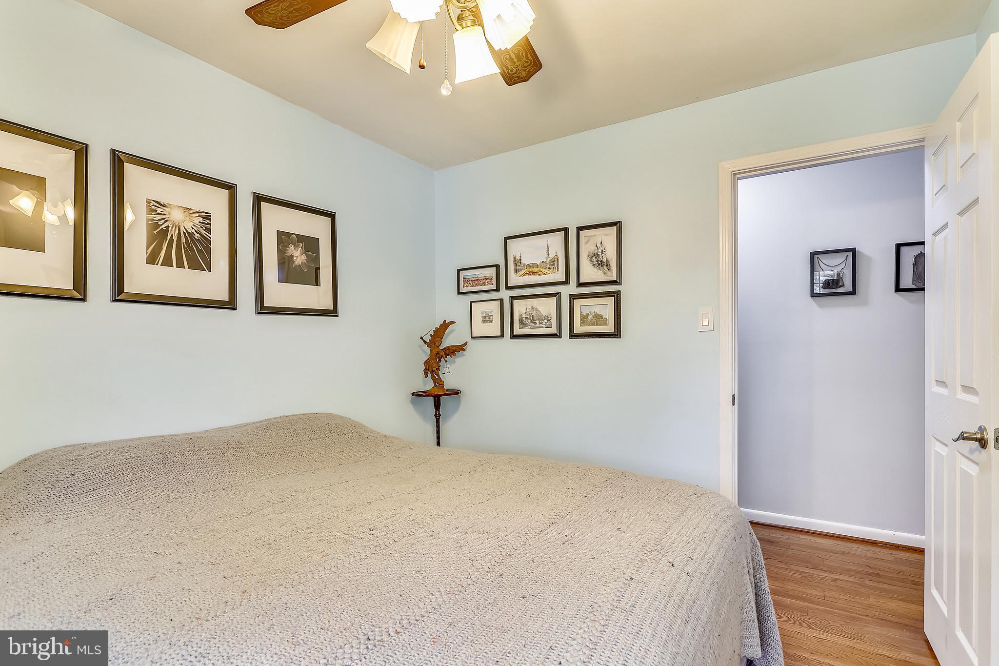 6671 Ridgeway Drive Springfield, VA 22150 - Photo 21 of 53 a bedroom with a bed and a painting on the wall