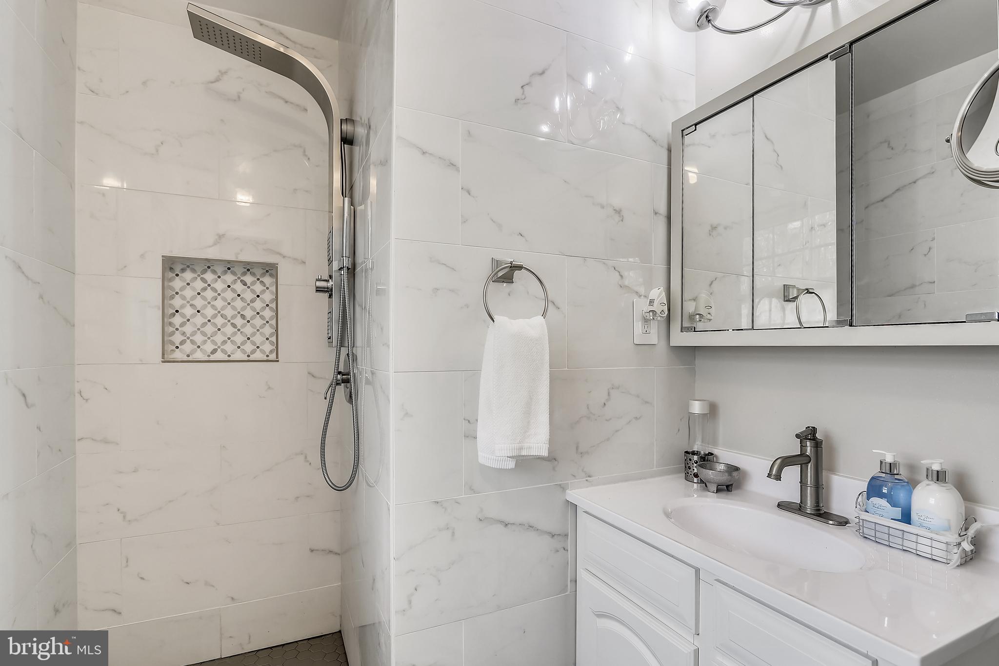 6671 Ridgeway Drive Springfield, VA 22150 - Photo 30 of 53 a bathroom with a sink a vanity and shower