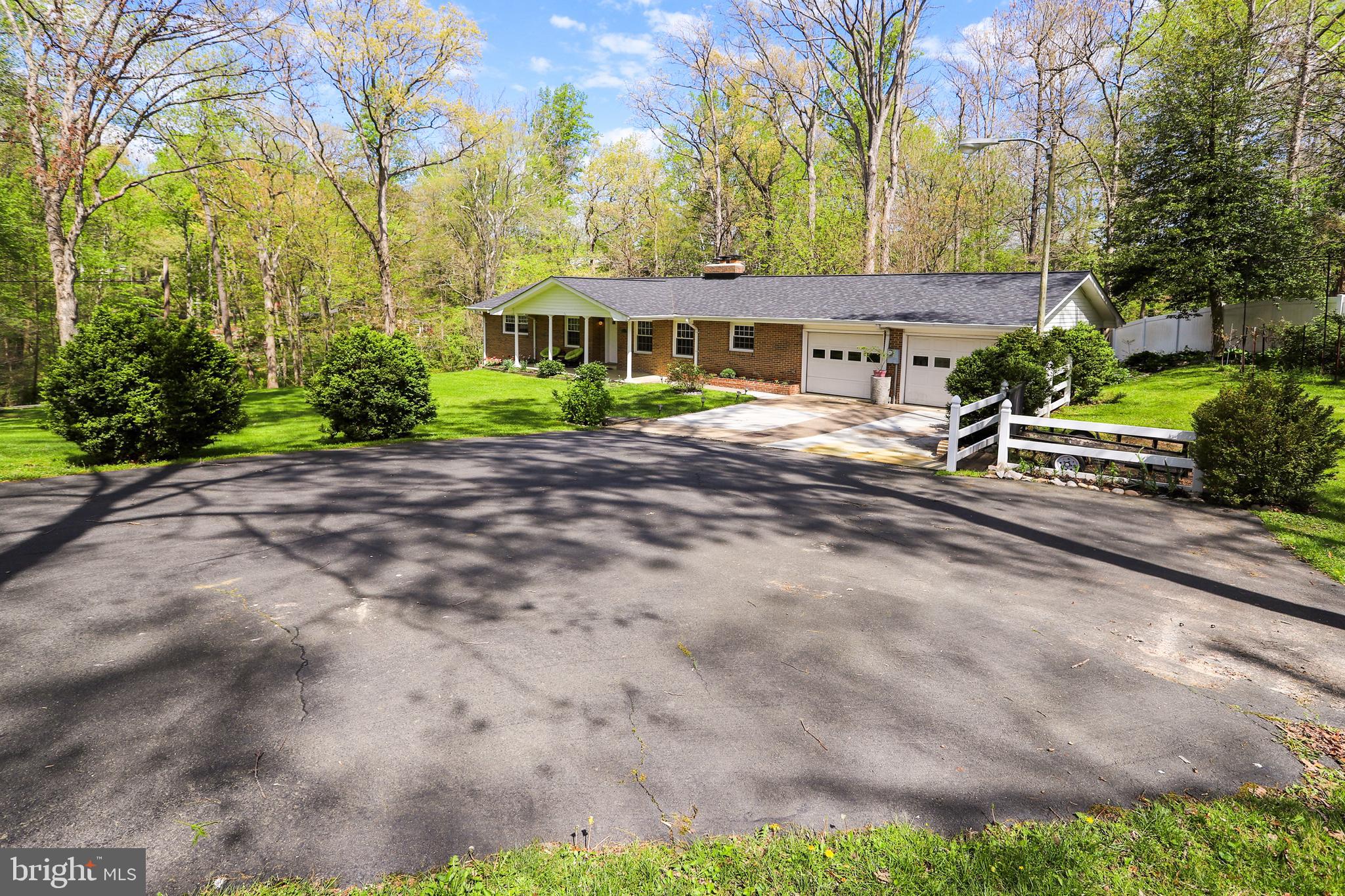 6671 Ridgeway Drive Springfield, VA 22150 - Photo 44 of 53 a front view of a house with a garden