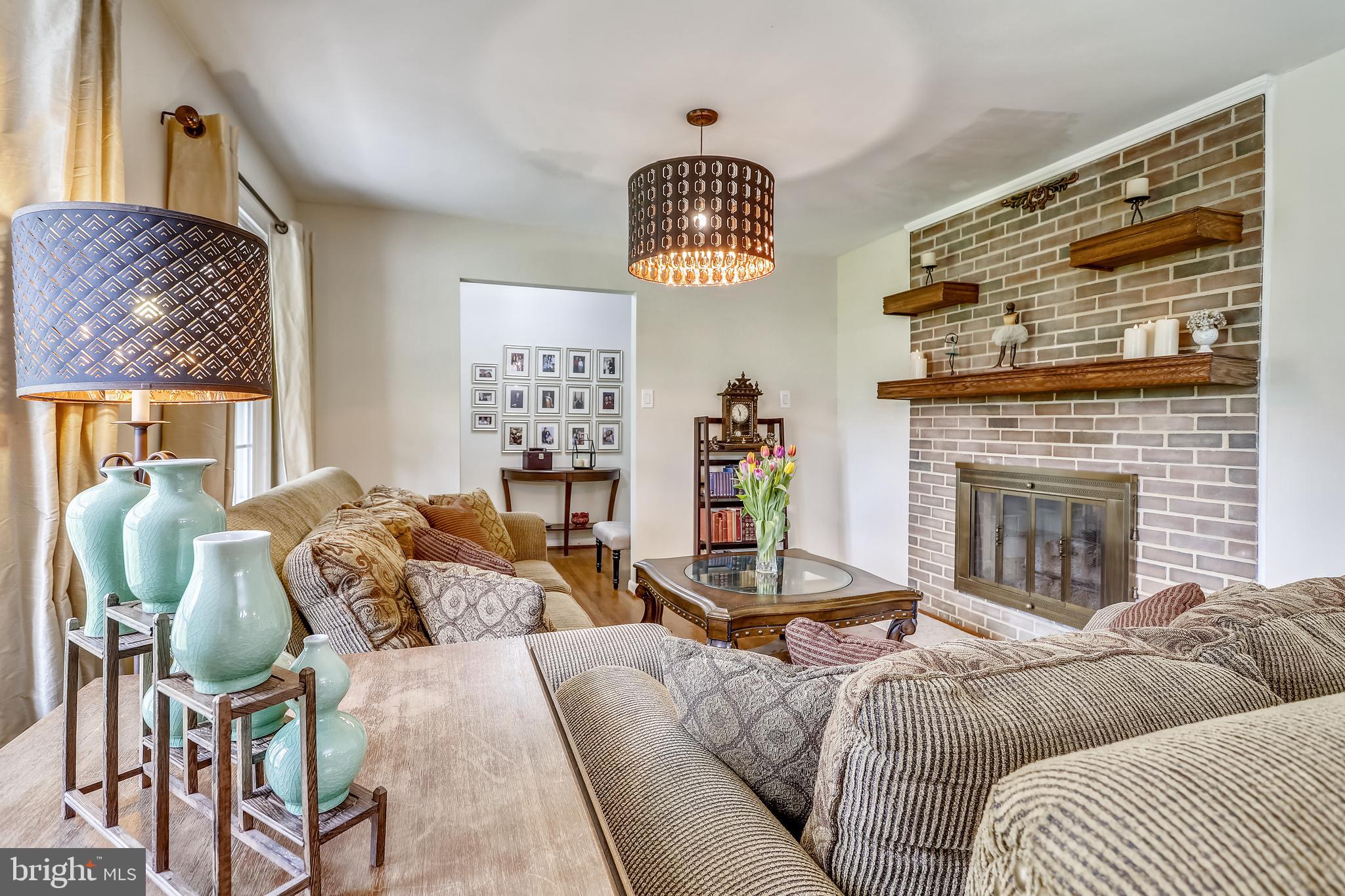 6671 Ridgeway Drive Springfield, VA 22150 - Photo 7 of 53 a living room with furniture a fireplace and a large window