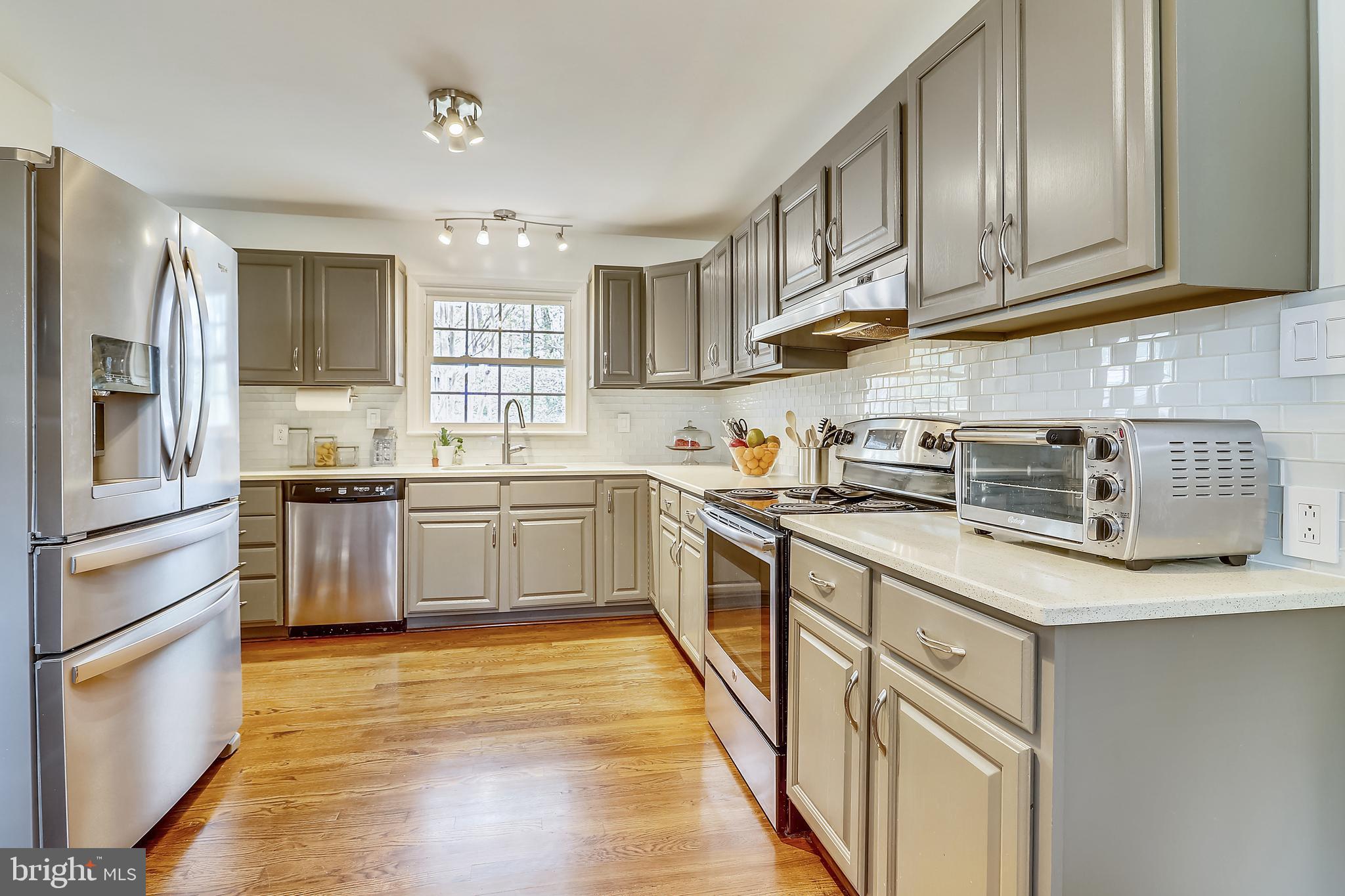 6671 Ridgeway Drive Springfield, VA 22150 - Photo 10 of 53 a kitchen with stainless steel appliances granite countertop a stove a sink dishwasher and a refrigerator