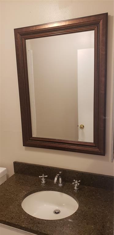2052 Kings Highway, Unit 7 Clearwater, FL 33755 - Photo 7 of 16 a bathroom with a sink and a mirror