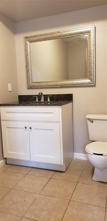 2052 Kings Highway, Unit 7 Clearwater, FL 33755 - Photo 9 of 16 a bathroom with a sink a toilet and vanity