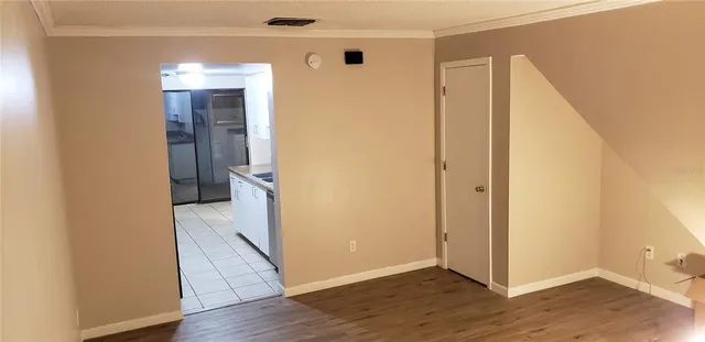 a view of a hallway with wooden floor