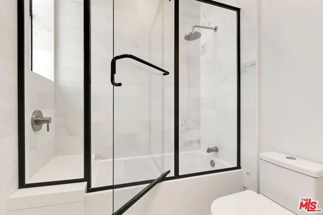 a bathroom with a glass shower door