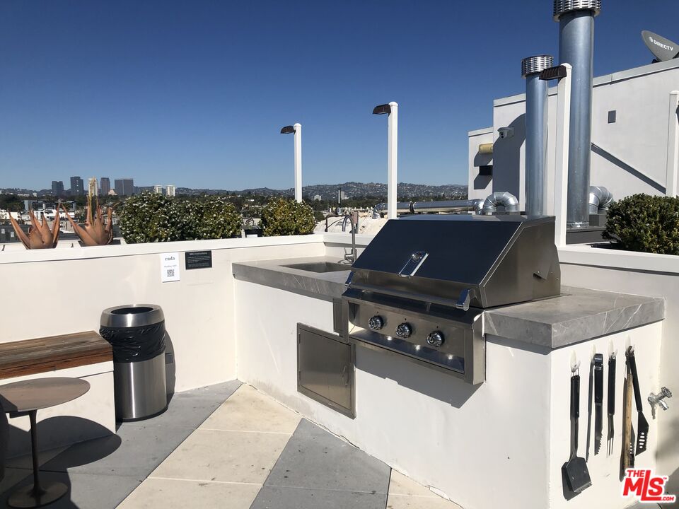 3833 Dunn Drive, Unit PH2 Culver City, CA 90232 - Photo 16 of 19 a open kitchen with stainless steel appliances kitchen island a stove and a sink