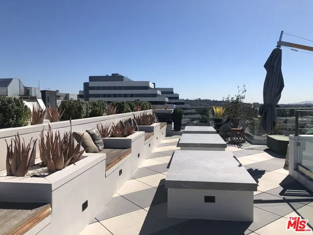 a view of city from balcony with seating space