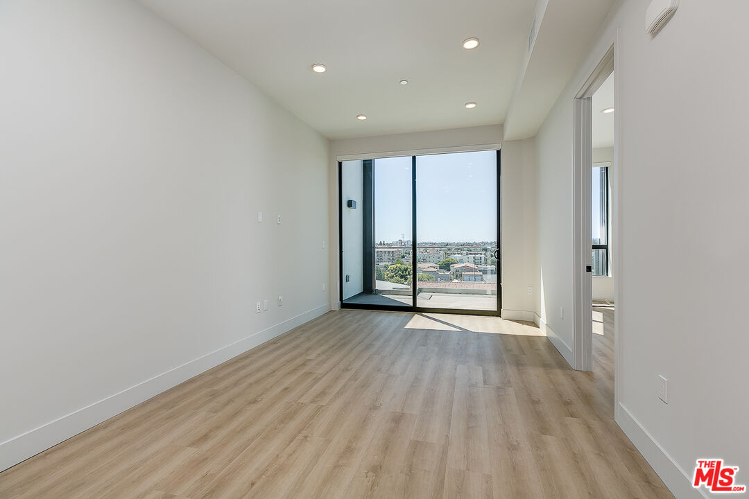 3833 Dunn Drive, Unit PH2 Culver City, CA 90232 - Photo 3 of 19 a view of an empty room with wooden floor and a window