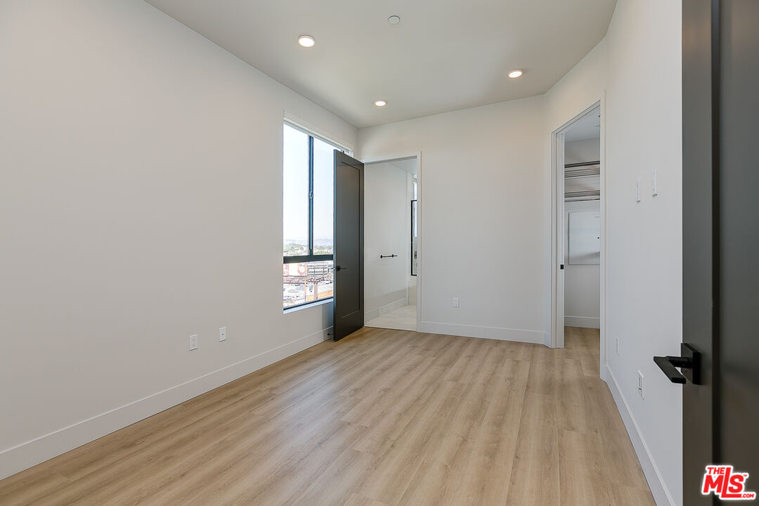 3833 Dunn Drive, Unit PH2 Culver City, CA 90232 - Photo 5 of 19 wooden floor in an empty room with a window