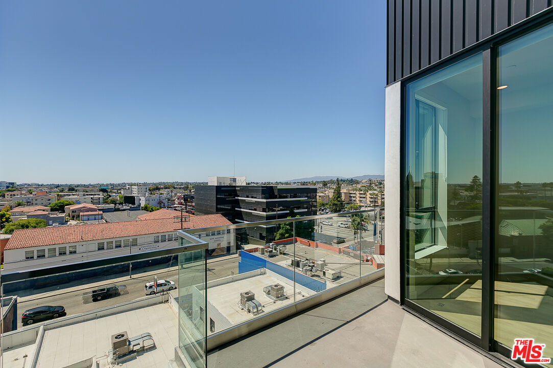3833 Dunn Drive, Unit PH2 Culver City, CA 90232 - Photo 8 of 19 a view of a balcony with chairs and wooden floor