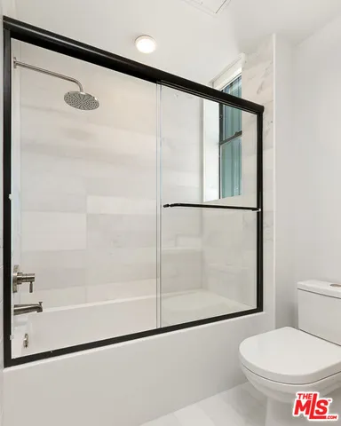 a bathroom with a shower and a toilet