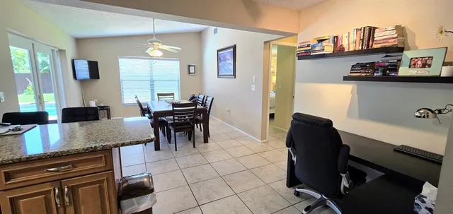 a kitchen with granite countertop cabinets and chairs