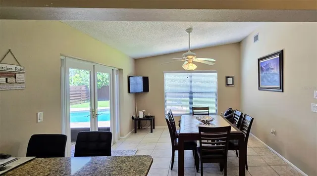 a view of a a dining room with furniture window and outside view