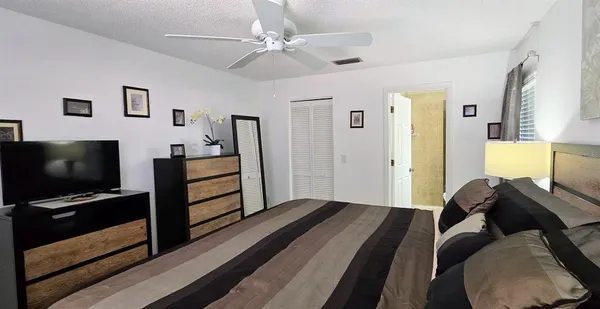 a bedroom with furniture and a flat screen tv