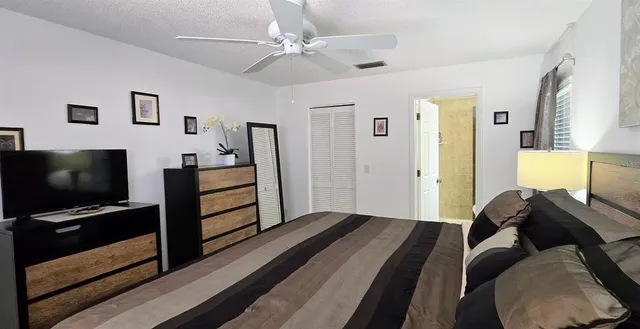 a bedroom with furniture and a flat screen tv