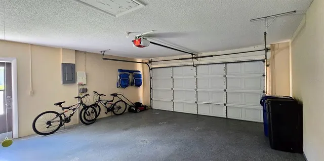 a view of garage with clothes and white walls