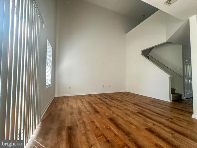 a view of a room with wooden floor and stairs