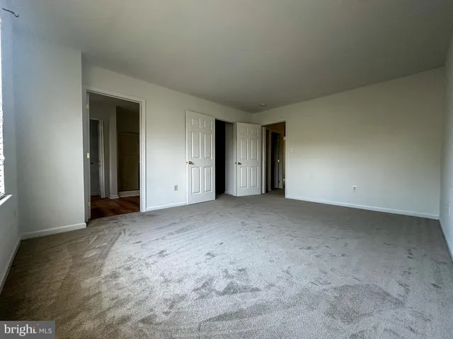 a view of an empty room and closet