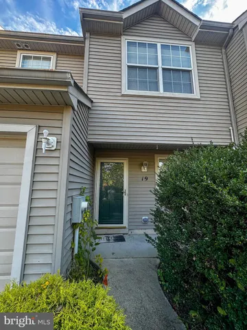 a view of a house with potted plants