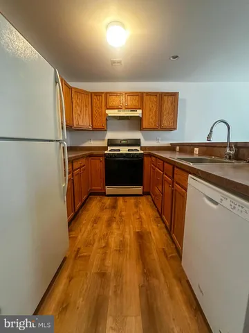 a large kitchen with stainless steel appliances granite countertop a stove and a sink