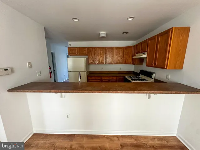 a view of a room with wooden floor