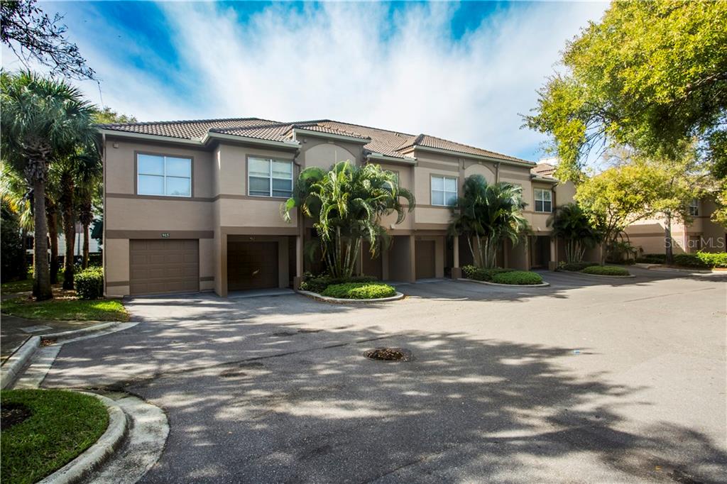 915 Normandy Trace Road, Unit 915 Tampa, FL 33602 - Photo 1 of 1 a front view of a house with a yard and potted plants