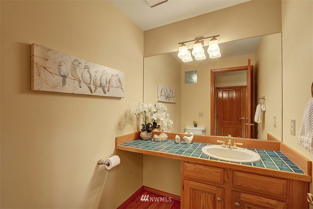 220 174th Street Southwest Bothell, WA 98012 - Photo 15 of 35 a bathroom with a granite countertop sink a large mirror and a shower