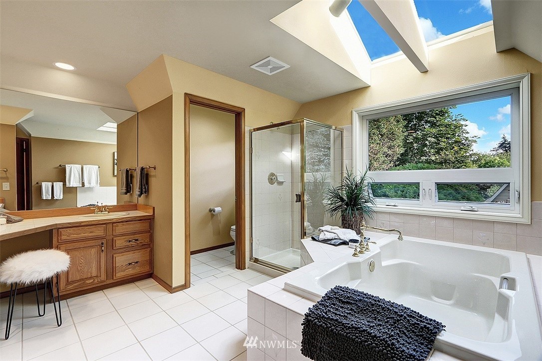 220 174th Street Southwest Bothell, WA 98012 - Photo 17 of 35 a bathroom with a tub a sink and a large mirror