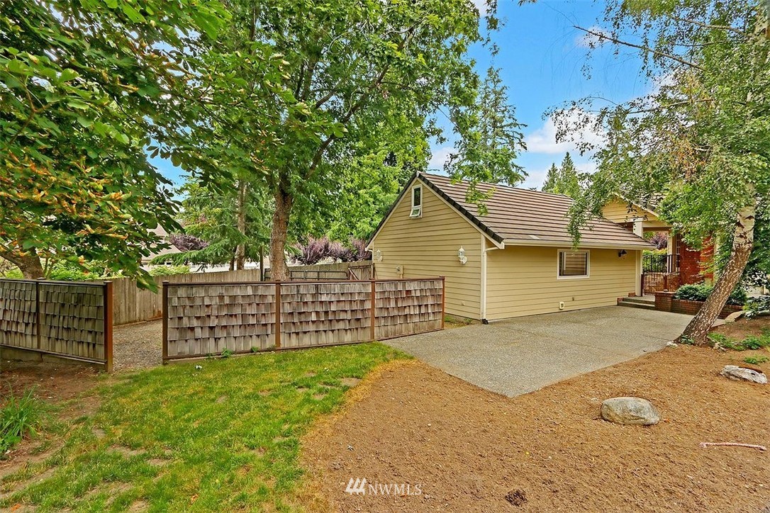 220 174th Street Southwest Bothell, WA 98012 - Photo 31 of 35 a view of a yard with wooden fence and trees