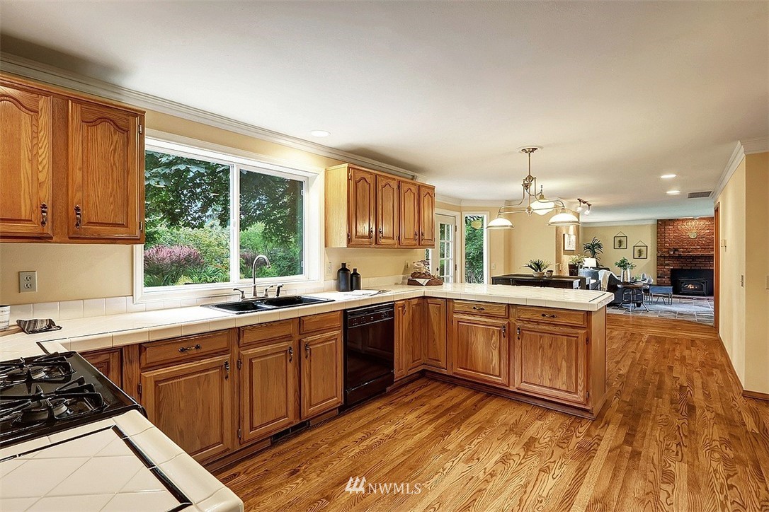 220 174th Street Southwest Bothell, WA 98012 - Photo 5 of 35 a large kitchen with stainless steel appliances granite countertop a stove and a sink