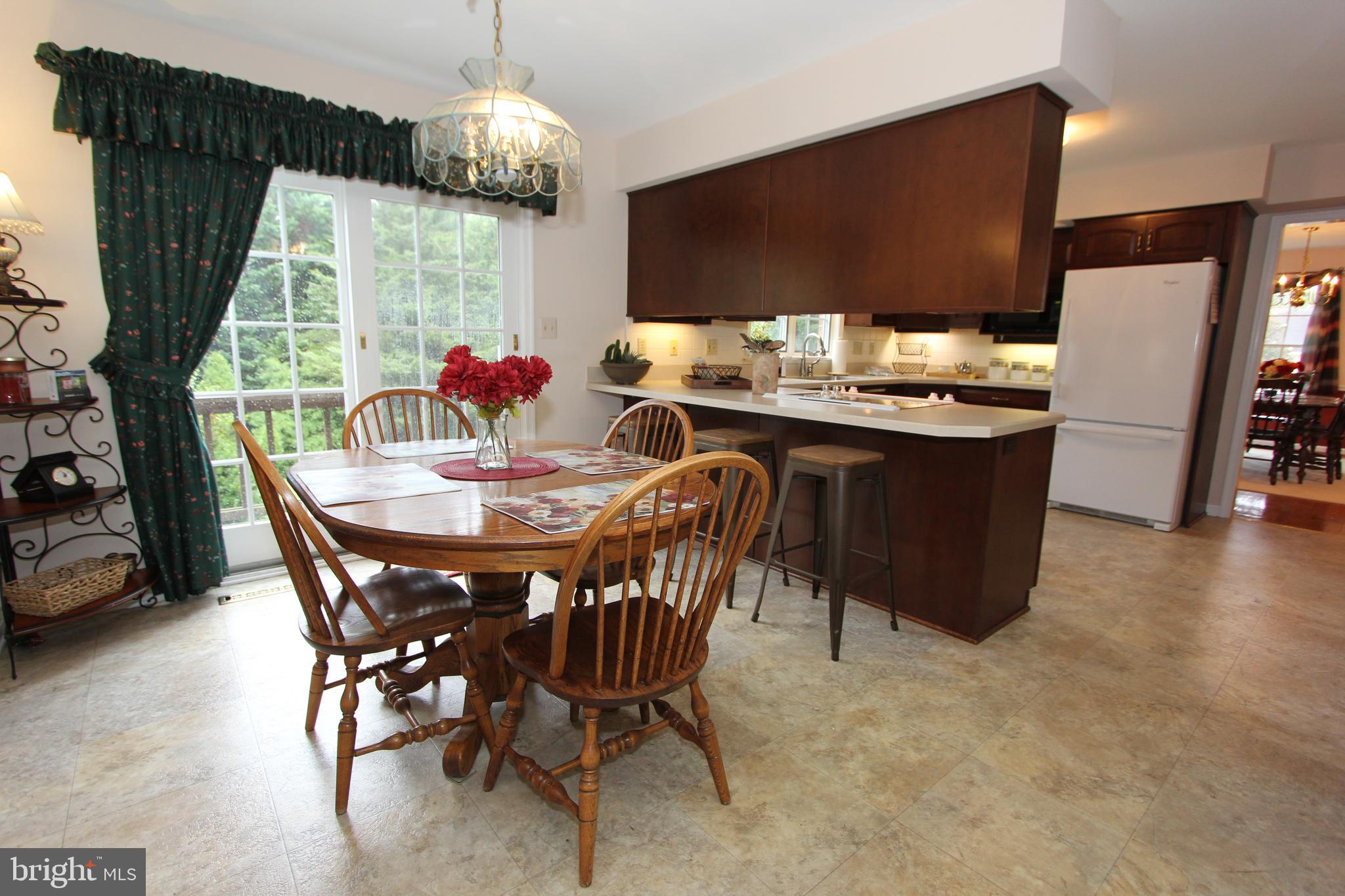 6670 Springhill Drive Frederick, MD 21702 - Photo 15 of 98 a dining room with furniture a chandelier and window