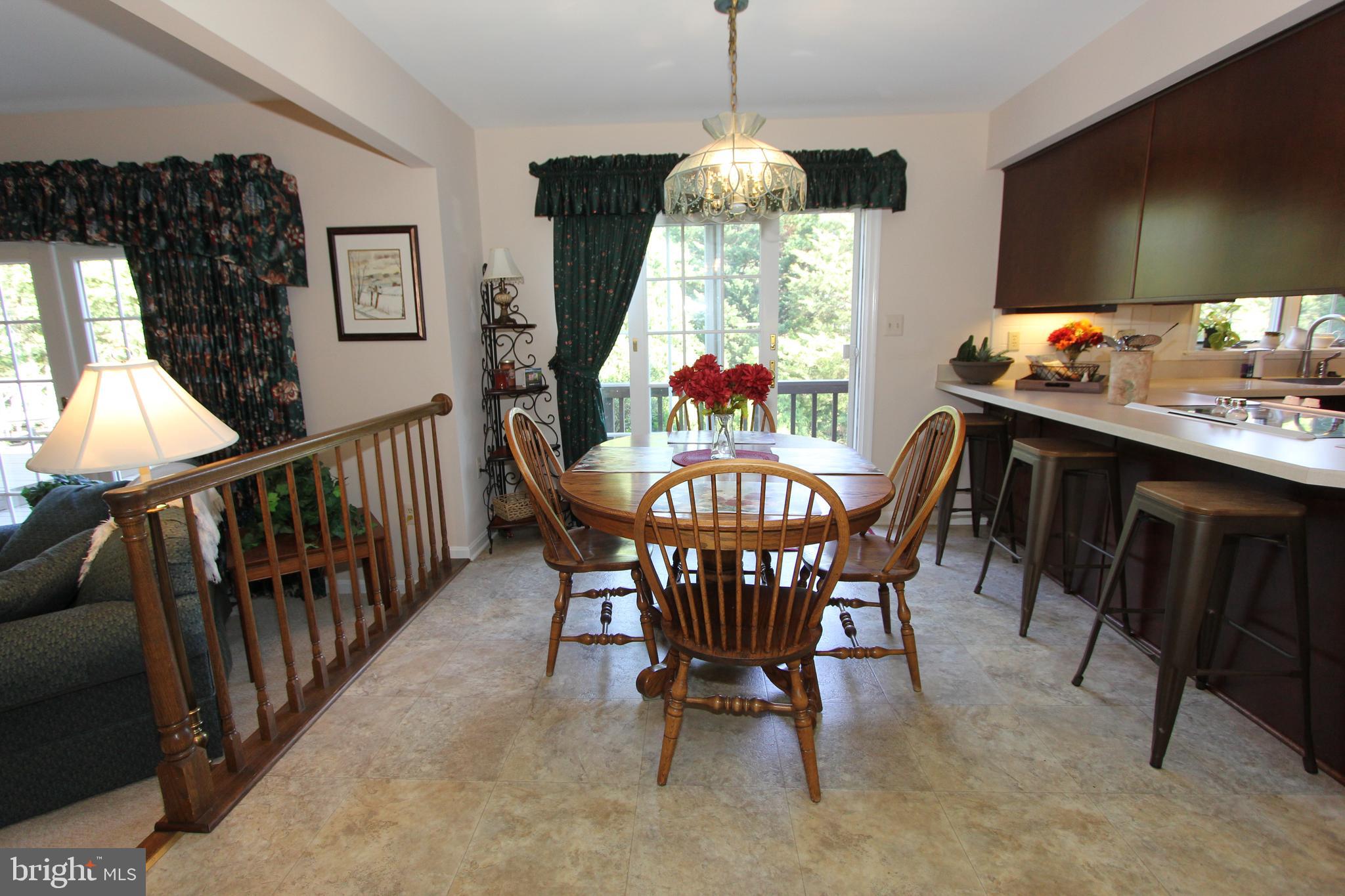 6670 Springhill Drive Frederick, MD 21702 - Photo 17 of 98 a view of a dining room with furniture window and wooden floor
